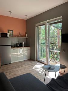 a living room with a couch and a table at 4 winds Zephyrus in Palanga