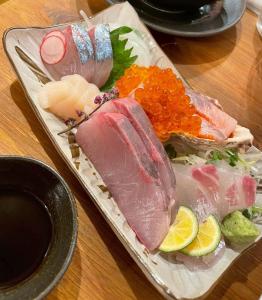 a tray of sushi with meat and vegetables on a table at Nagasaki - House - Vacation STAY 19522 in Nagasaki