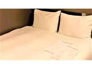 a white bed with white sheets and pillows at Smile Hotel Nagoya Sakae - Vacation STAY 66683v in Nagoya +39 photos