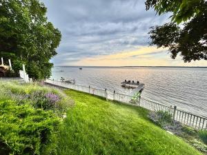 a group of people in a boat on the water at Spectacular Suttons Bay Stay - Game Room Kayaks Pizza Oven & More in Suttons Bay