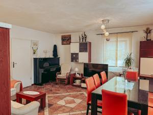 a living room with a table and chairs and a fireplace at Apartments Ivanović in Idrija