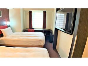 a hotel room with two beds and two windows at Smile Hotel Nagoya Sakae - Vacation STAY 66744v in Nagoya +36 photos