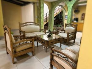 a living room with chairs and a table and a couch at Mitru Express Tupiza in Tupiza