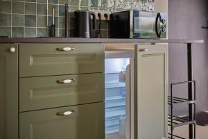 a kitchen with a counter with a microwave on it at Italian House Bieszczady in Bachlawa +11 photos