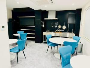 a kitchen with white tables and blue chairs at Luxury Hills - Vacation STAY 19539 in Fukuoka