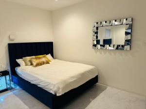 a bedroom with a bed with a mirror on the wall at Luxury Hills - Vacation STAY 19539 in Fukuoka