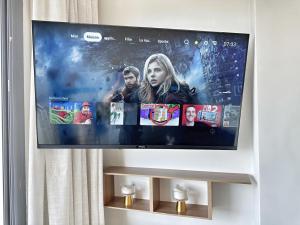 a flat screen tv hanging on a wall at 3-marina Serena ocean-studio chic vue mer in Casablanca