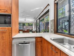 a kitchen with a sink and a dishwasher at Villas at Hastings Point by Kingscliff Accommodation in Hastings Point +14 photos