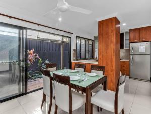 a kitchen and dining room with a table and chairs at Villas at Hastings Point by Kingscliff Accommodation in Hastings Point