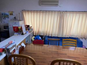 a kitchen with a table and chairs in a room at HANAMIDORI Oppara no Yado - Vacation STAY 67865v in Gujo