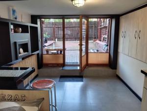a kitchen with a door open to a patio at Hostel Texas in Suwałki