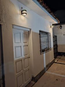 a door with a light on the side of a building at Sonido de mar in Santa Teresita