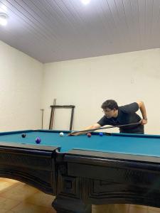a man standing next to a pool table at 02- Cachoeiras do Pinga, Tianguá in Tianguá