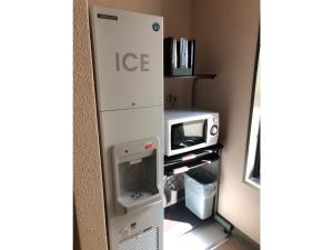 a small kitchen with a microwave and a toaster oven at Smile Hotel Tokyo Nishikasai - Vacation STAY 67938v in Tokyo