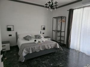 a bedroom with a bed with two stuffed animals on it at La Piuma Cagliari in Cagliari