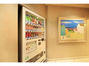 a vending machine with soda and a picture on the wall at Smile Hotel Tokyo Nishikasai - Vacation STAY 67966v in Tokyo +14 photos