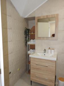 a bathroom with a sink and a mirror at Apartmani Kaić in Livno +49 photos