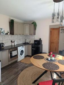 a kitchen with a table and a kitchen with a stove at Marta's Apartment in Kuldīga