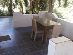 a table and chairs on a tiled patio at Chácara Sonho Meu Juquitiba SP in Juquitiba