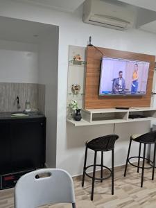 a living room with two chairs and a flat screen tv at Apartamento por temporada no centro de Macapá - mobiliado in Macapá +12 photos