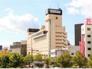 a tall building with a sign on top of it at Smile Hotel Wakayama - Vacation STAY 69556v in Wakayama