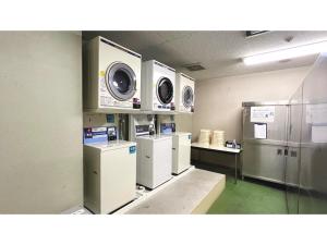 a laundry room with washers and dryers on display at Smile Hotel Nabari - Vacation STAY 70534v in Nabari