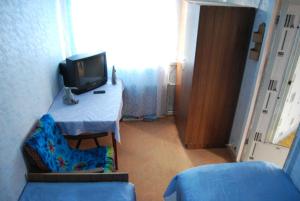 Slavyansky Dom Guest House في Alakhadzi: غرفة بها طاولة مع تلفزيون