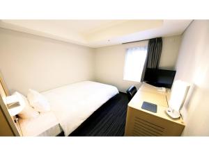 大阪市にあるSmile Hotel Osaka Yotsubashi - Vacation STAY 73550vのベッドと机があるホテルの部屋