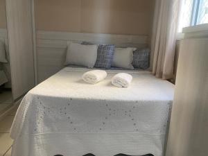 a bed with two towels on top of it at Apt Central em Águas Claras in Brasilia +22 photos