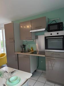 a small kitchen with a sink and a stove at Spacious, bright 4 bedroom, 80 m2 in Hérouville-Saint-Clair