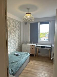 a bedroom with a bed and a desk and a window at Spacious, bright 4 bedroom, 80 m2 in Hérouville-Saint-Clair +3 photos