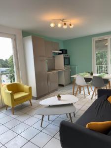 a living room with a couch and a table at Spacious, bright 4 bedroom, 80 m2 in Hérouville-Saint-Clair