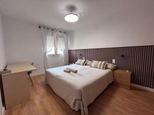 a bedroom with a bed with two towels on it at Baires&Blo Ático duplex, Terraza chillout exclusiva y vistas al mar in Benicarló +44 photos