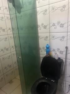 a bathroom with a toilet and a glass shower at Casa Maria in Belém