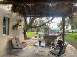 a patio with chairs and a table and a fountain at La quinta in Piquete +1 photo