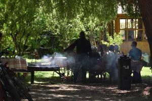 a group of people sitting at a table in a park at Hostal Pando in Santa Cruz