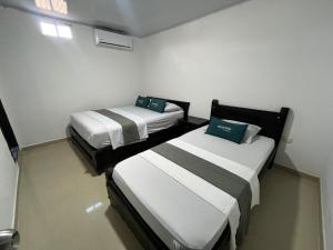 Postel nebo postele na pokoji v ubytování Hotel Marlon