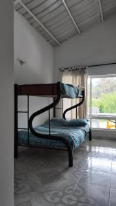 two bunk beds in a room with a window at Finca en Chinauta, piscina, jacuzzi, BBQ in Boquerón