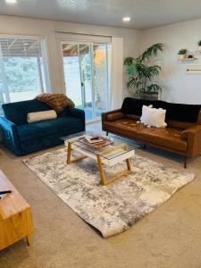a living room with two couches and a coffee table at Siesta Sunset in Boise