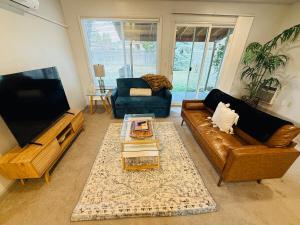 a living room with a couch and a tv at Siesta Sunset in Boise