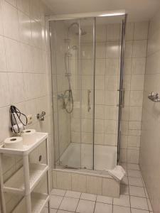 a bathroom with a shower and a sink at Hotel Eisenbahn in Karlstadt