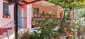 a balcony with potted plants on a building at Günışığı Pansiyon & Apart in Koycegiz