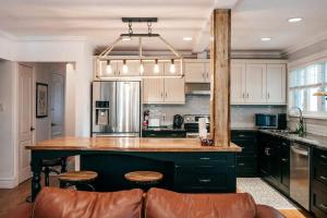 a kitchen with a large island with a counter top at CHALET AT THE BEACH in Otter Lake