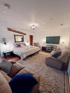 a bedroom with a bed and a flat screen tv at CHALET AT THE BEACH in Otter Lake +70 photos