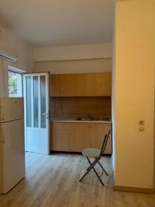 an empty kitchen with a chair and a refrigerator at City & Sea Hideout in Himare