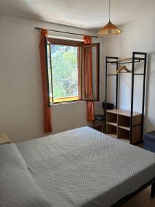 a bedroom with a bed and a window at VistaMare21 in Cala Gonone