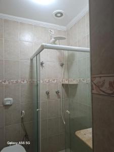 a shower with a glass door in a bathroom at Casa Guarujá in Guarujá