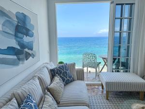 a living room with a couch and a view of the ocean at Casa Ale, Stunning Sea Views in Las Aguas