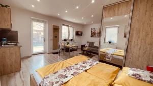 a bedroom with a bed and a kitchen with a table at Eugen Apartmán in Veľký Meder