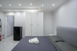 a bedroom with a bed with white shoes on it at Smart’s House Deluxe Quartieri Spagnoli in Naples